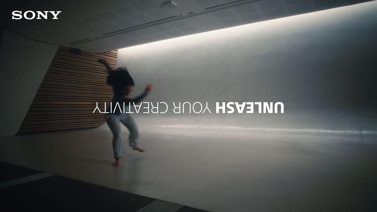 a man standing in front of a wall in a room