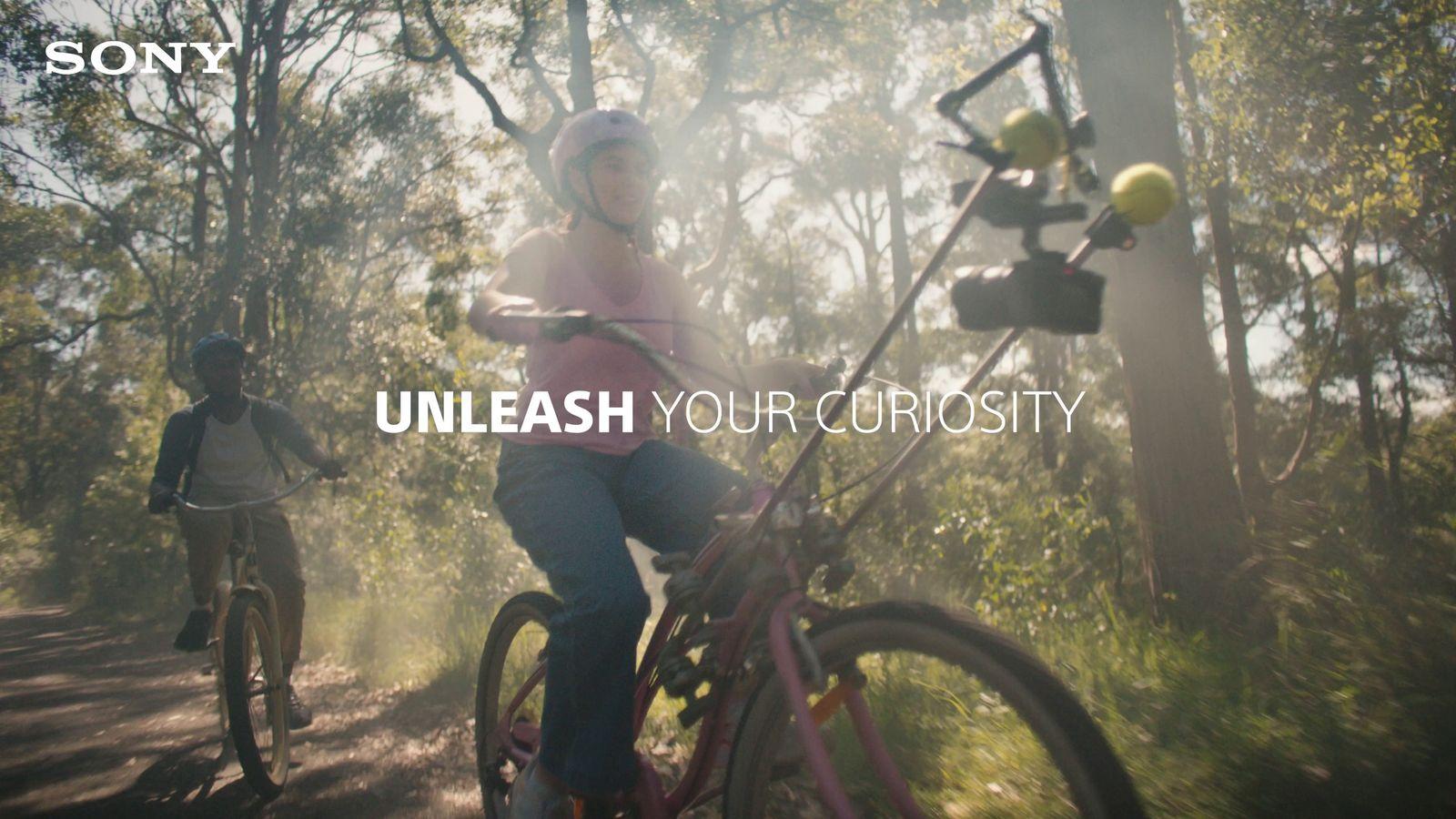 a man riding a bike down a dirt road