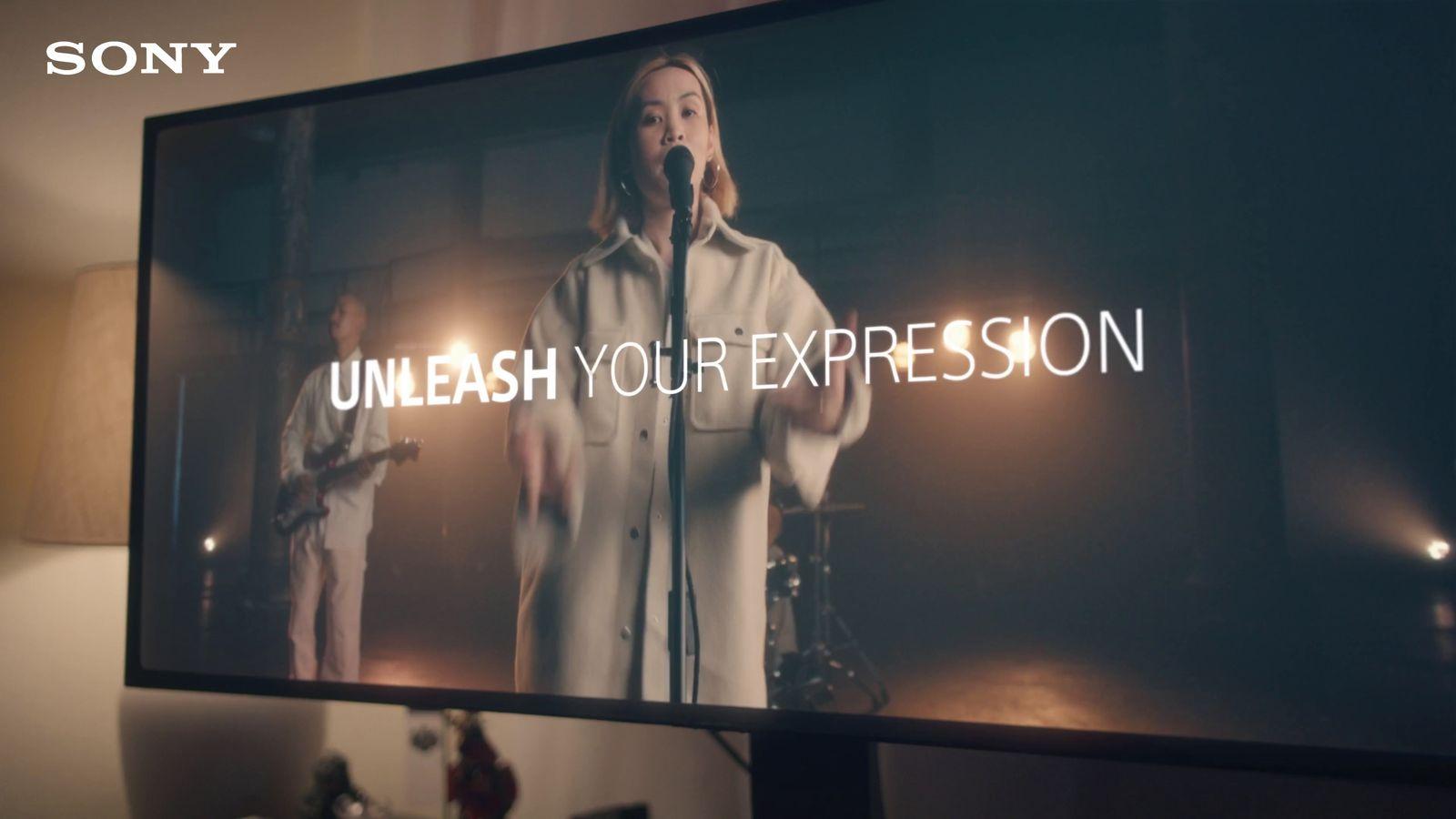 a person standing in front of a large screen