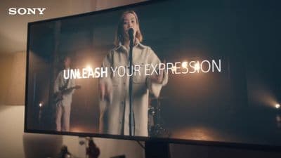 a person standing in front of a large screen