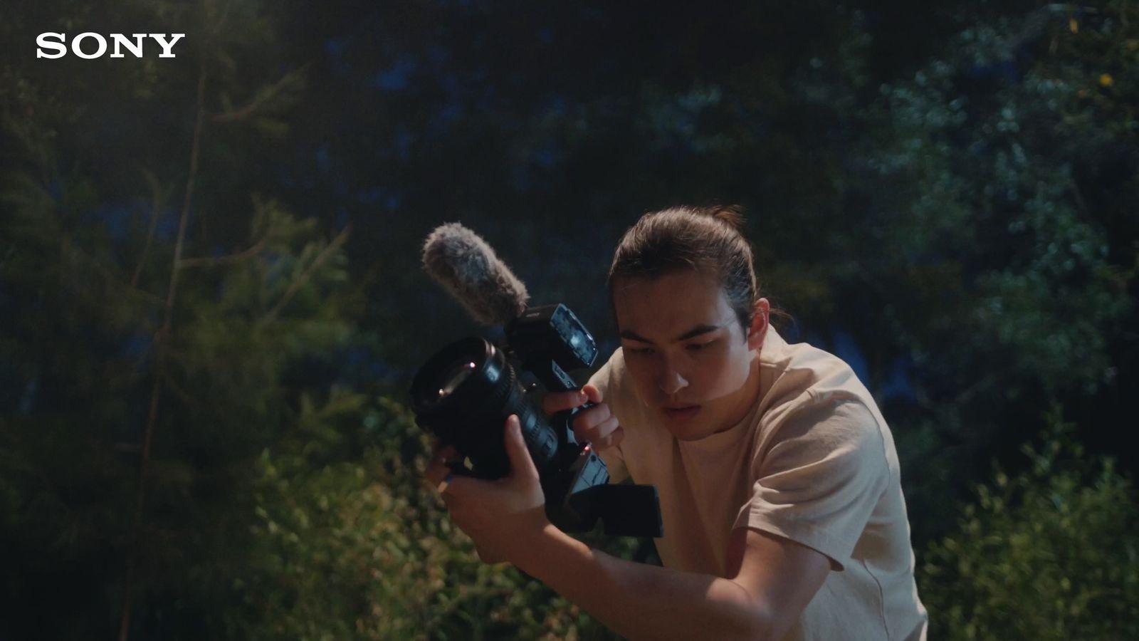 a woman holding a camera in front of her face