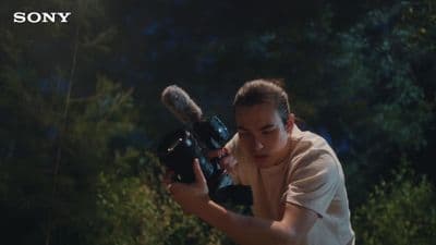 a woman holding a camera in front of her face