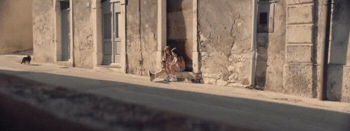 a woman standing in a doorway of an old building