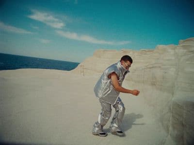 a man riding a skateboard on top of a sandy beach