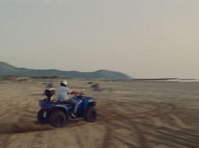 a person riding an atv on a dirt road
