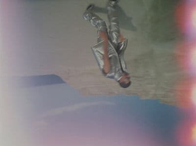 a man flying through the air while riding a snowboard