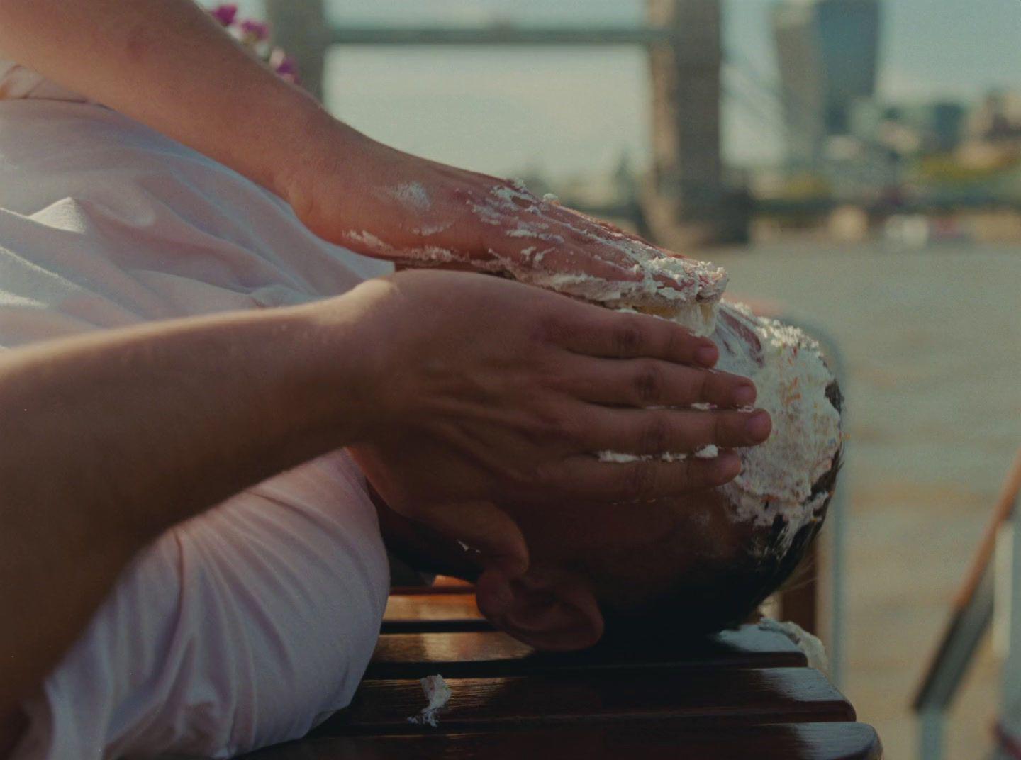 a person with their hands on their face on a bench