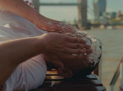 a person with their hands on their face on a bench