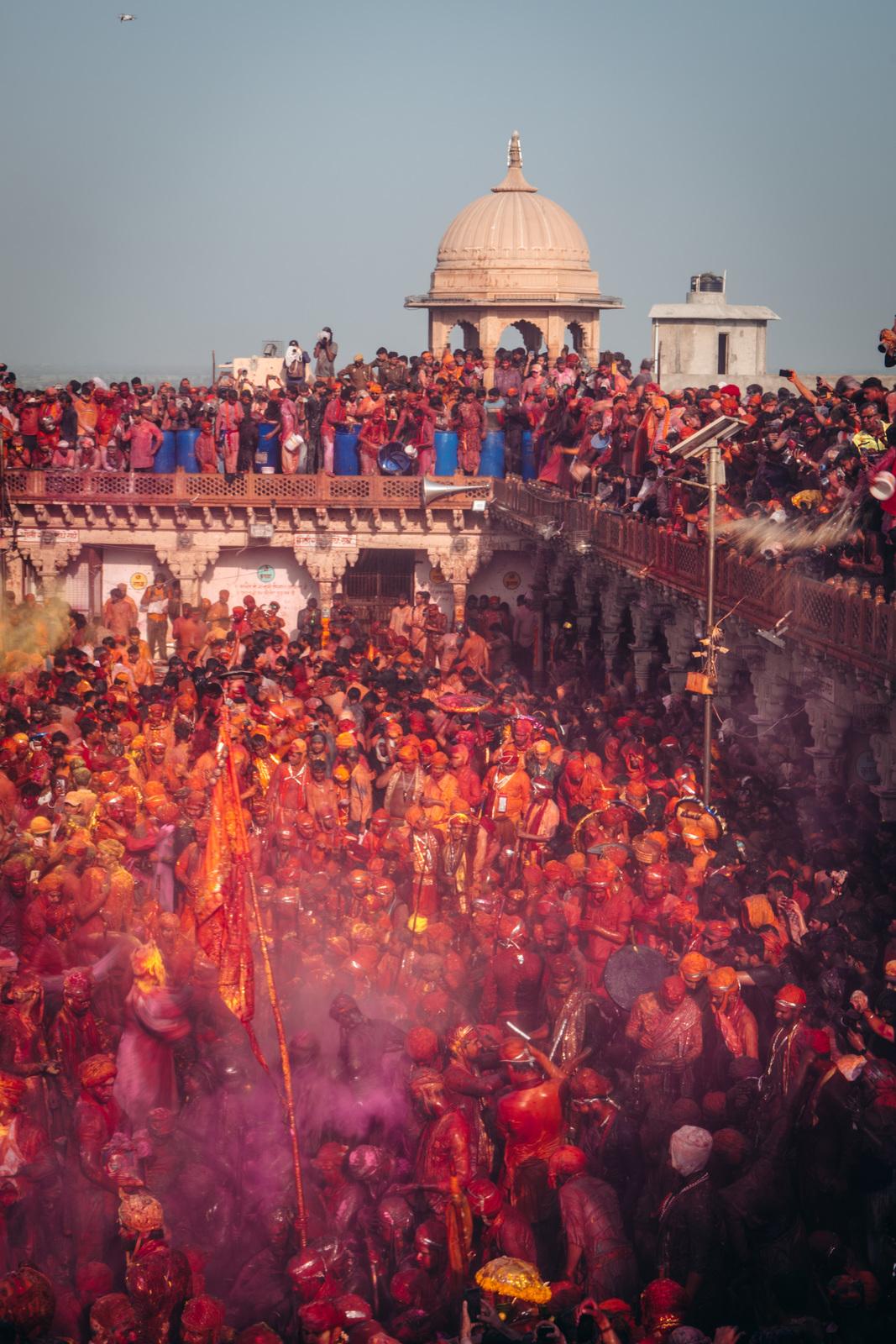 a crowd of people standing around each other