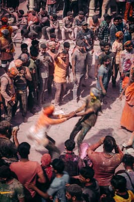 a crowd of people standing around a man on a skateboard