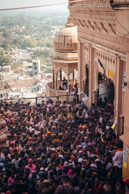 a large crowd of people standing in front of a building