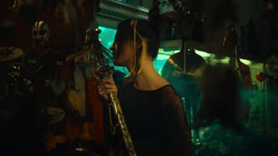a woman standing in a room holding a bat