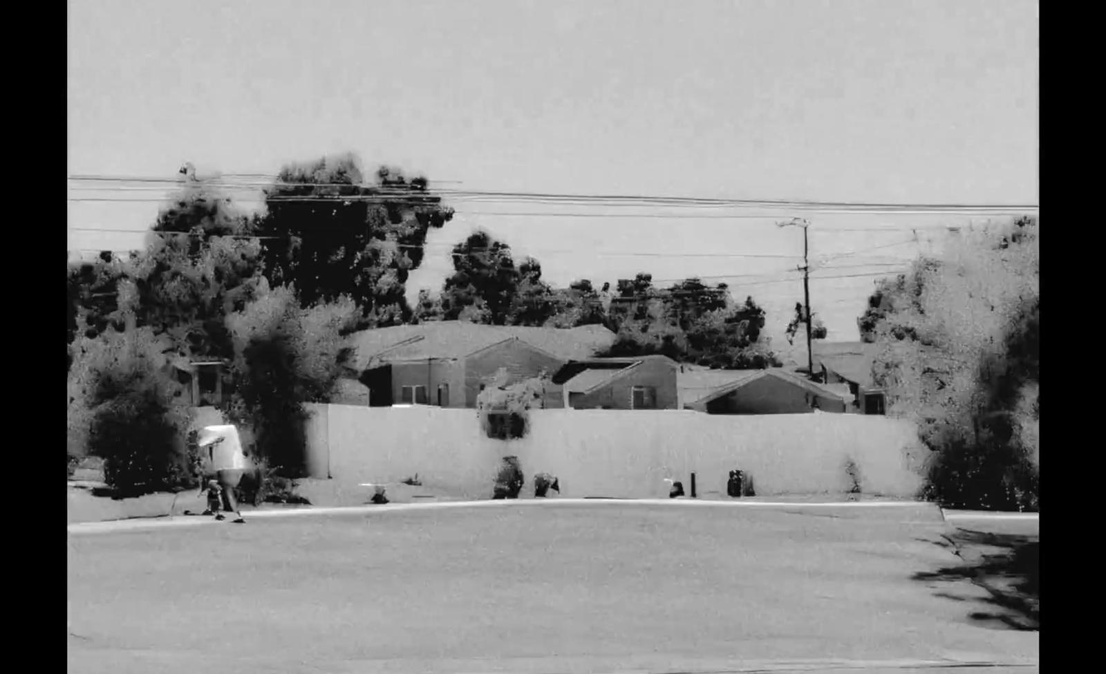 a black and white photo of a person on a skateboard