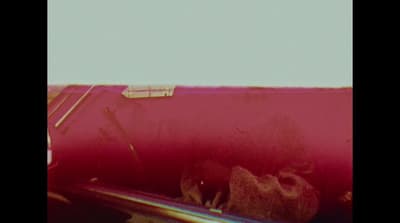 a close up of a car door handle with a red tint