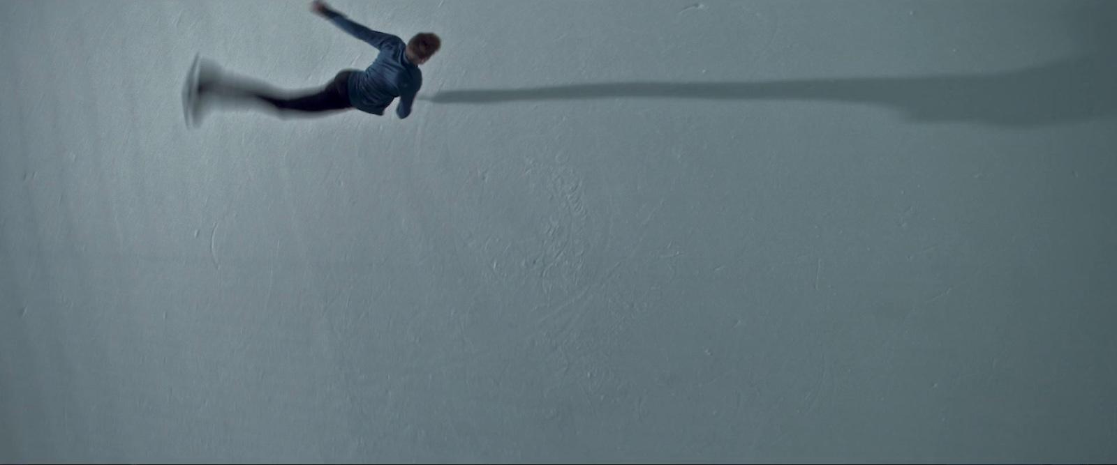 a man flying through the air while riding a snowboard