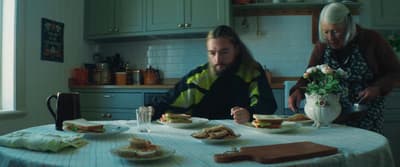 a man and woman sitting at a table with plates of food