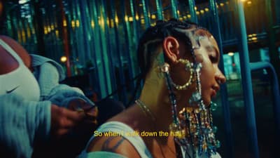 a woman with a lot of beads on her head
