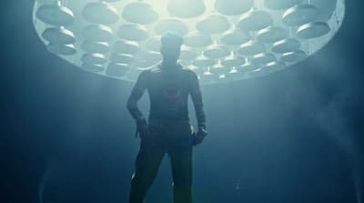 a man standing in front of a light in a room