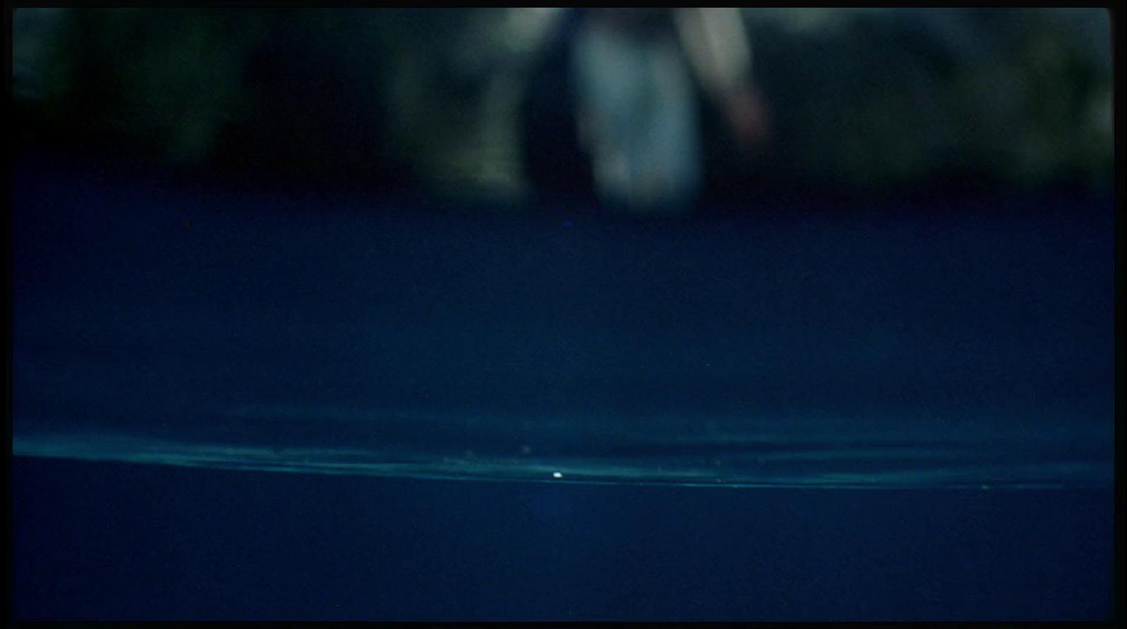 a blurry image of a person walking in the dark