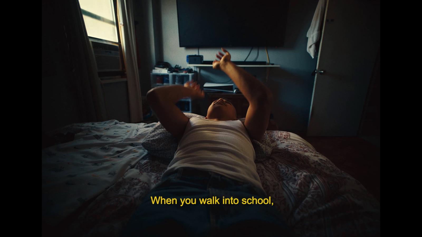 a person laying on a bed with a tv in the background