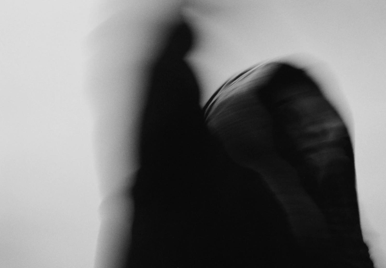 a blurry photo of a woman in a black dress