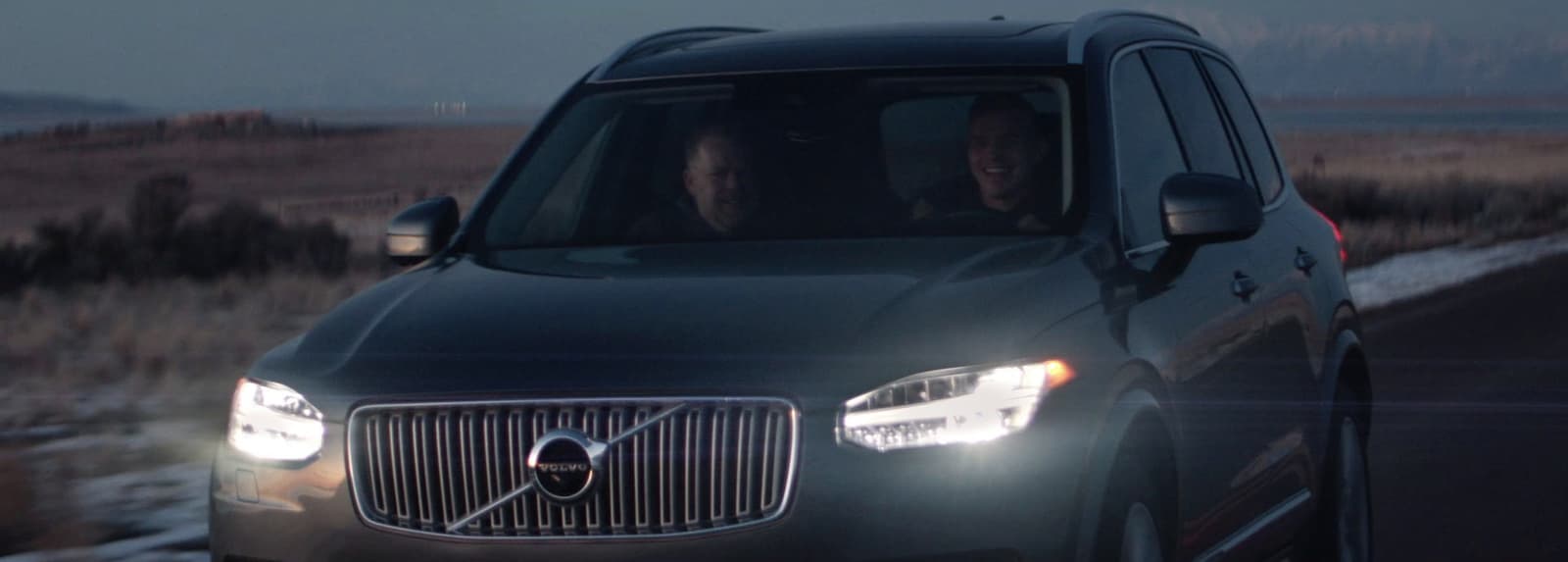 a couple of people in a car driving down a road