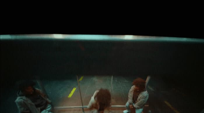 a group of people standing around in an aquarium