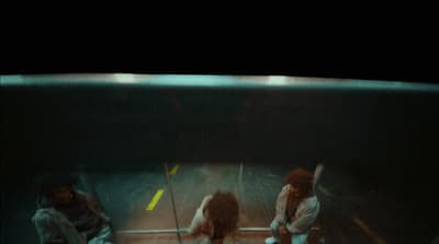 a group of people standing around in an aquarium