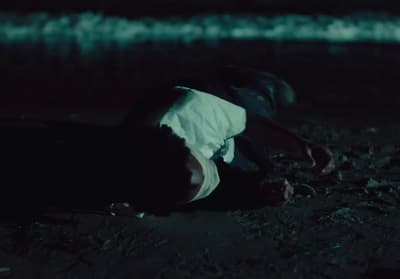 a person laying on the ground in the dark