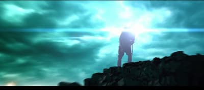 a man standing on top of a mountain under a cloudy sky