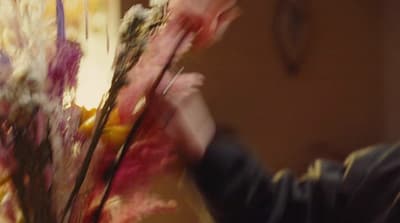 a blurry photo of a person holding a bouquet of flowers