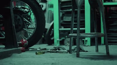 a motorcycle tire and a chair in a garage