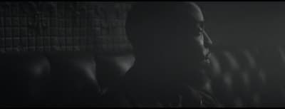 a black and white photo of a man in a dark room
