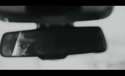 a man's reflection in a rear view mirror