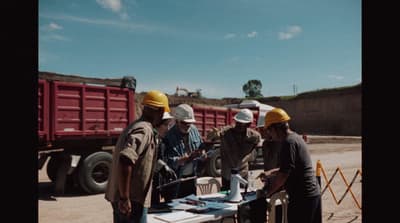 a group of men standing around a table