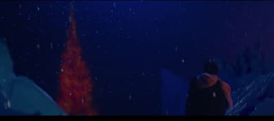 a person standing in the snow at night