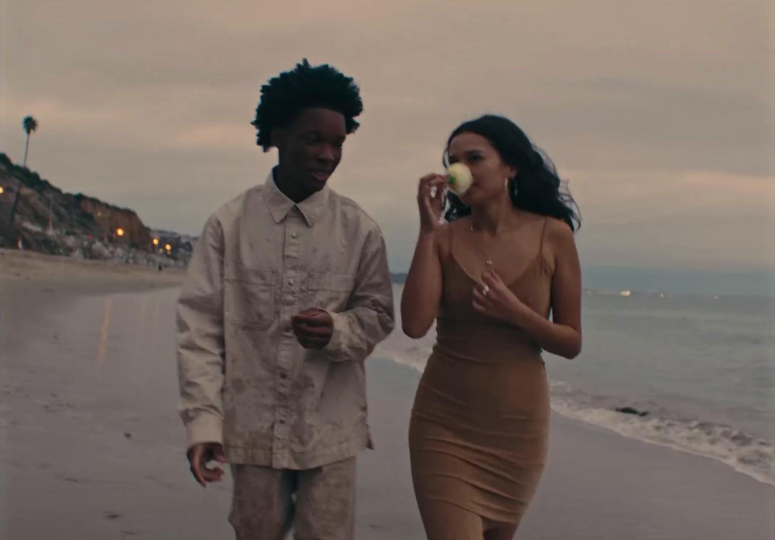 a man and a woman walking on the beach