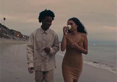 a man and a woman walking on the beach
