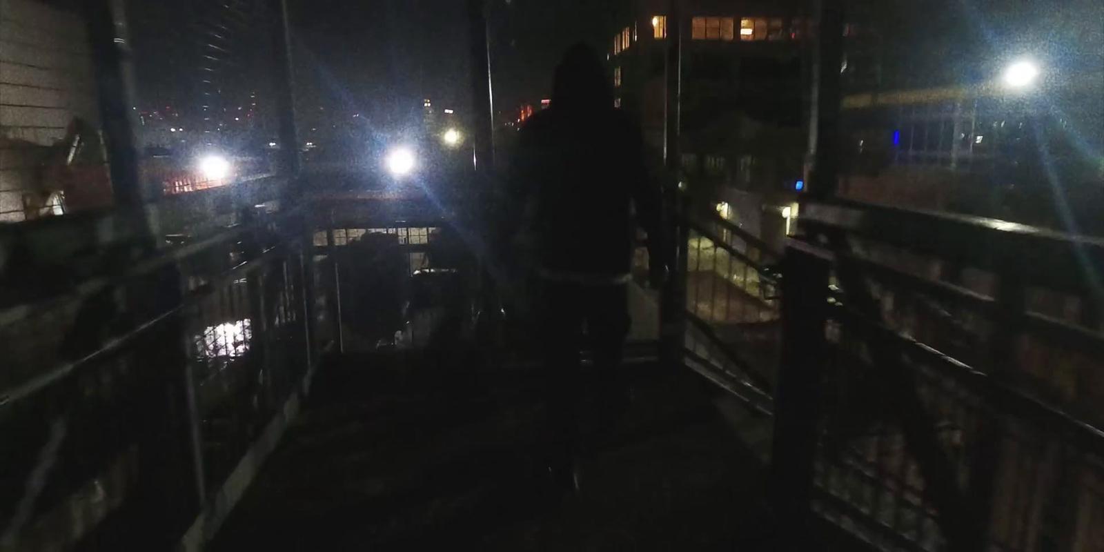a person standing on a balcony at night