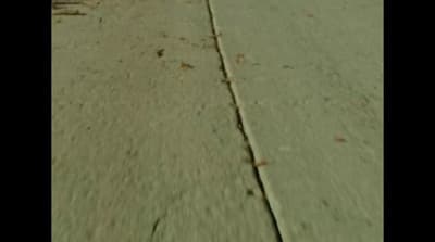 a person riding a skateboard down a street