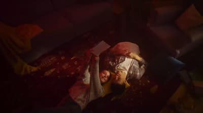 a couple of people laying on top of a bed
