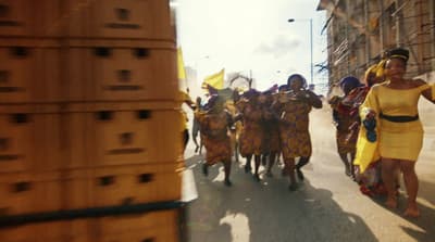 a group of people walking down a street