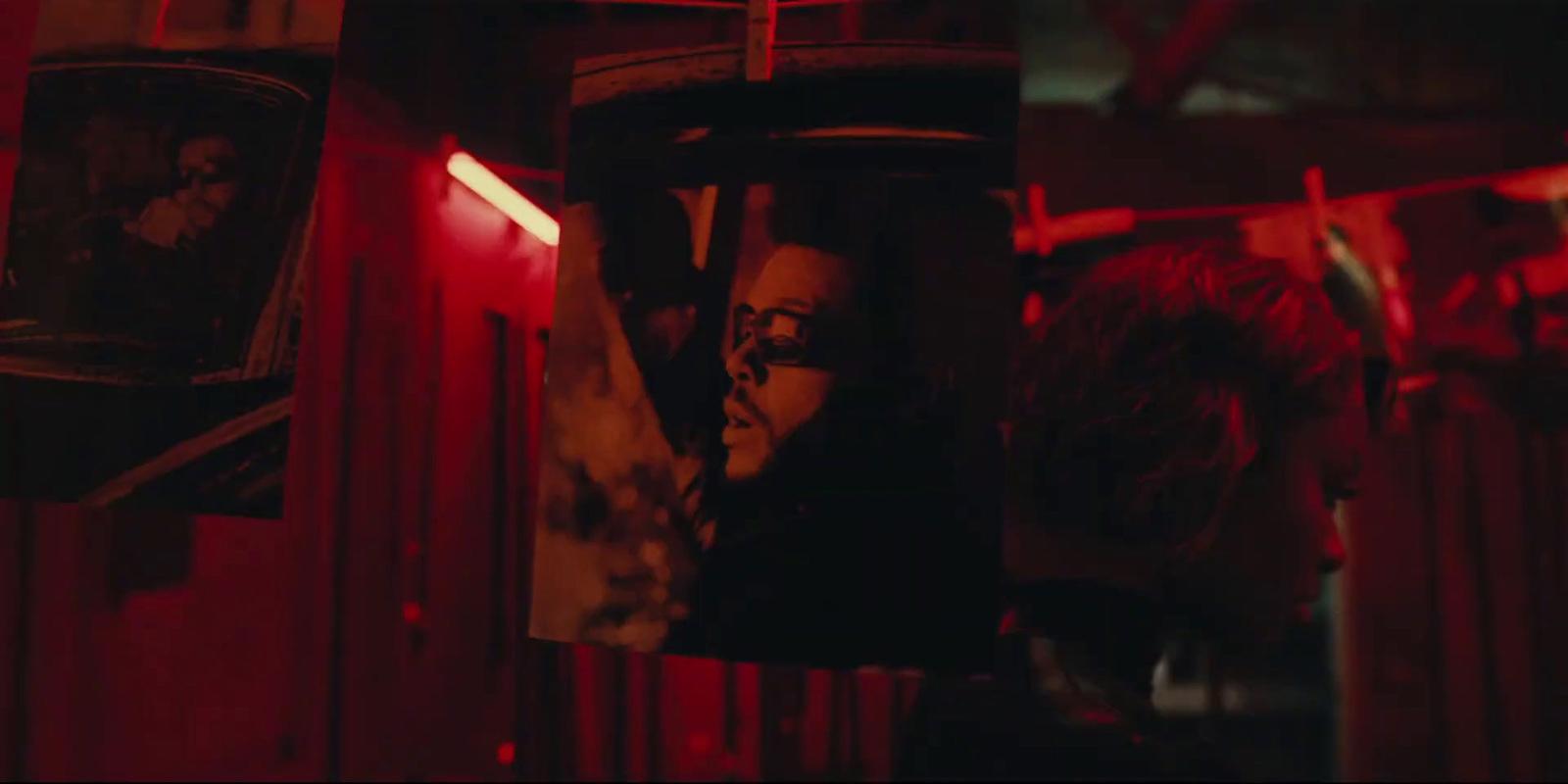 a woman in a dark room with red lights