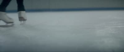 a person skating on an ice rink in the snow