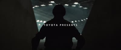 a person standing in a tunnel with the words toyota presents