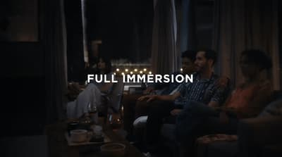 a group of people sitting around a living room together