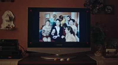 a flat screen tv sitting on top of a wooden table
