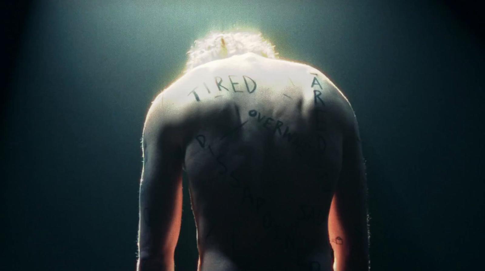 the back of a man with writing on his back