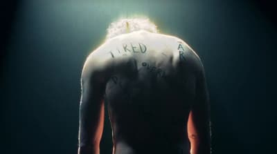 the back of a man with writing on his back