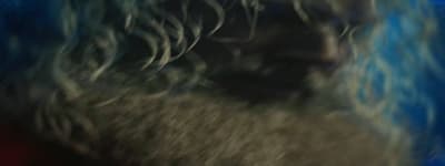 a blurry photo of a bearded man with blue hair